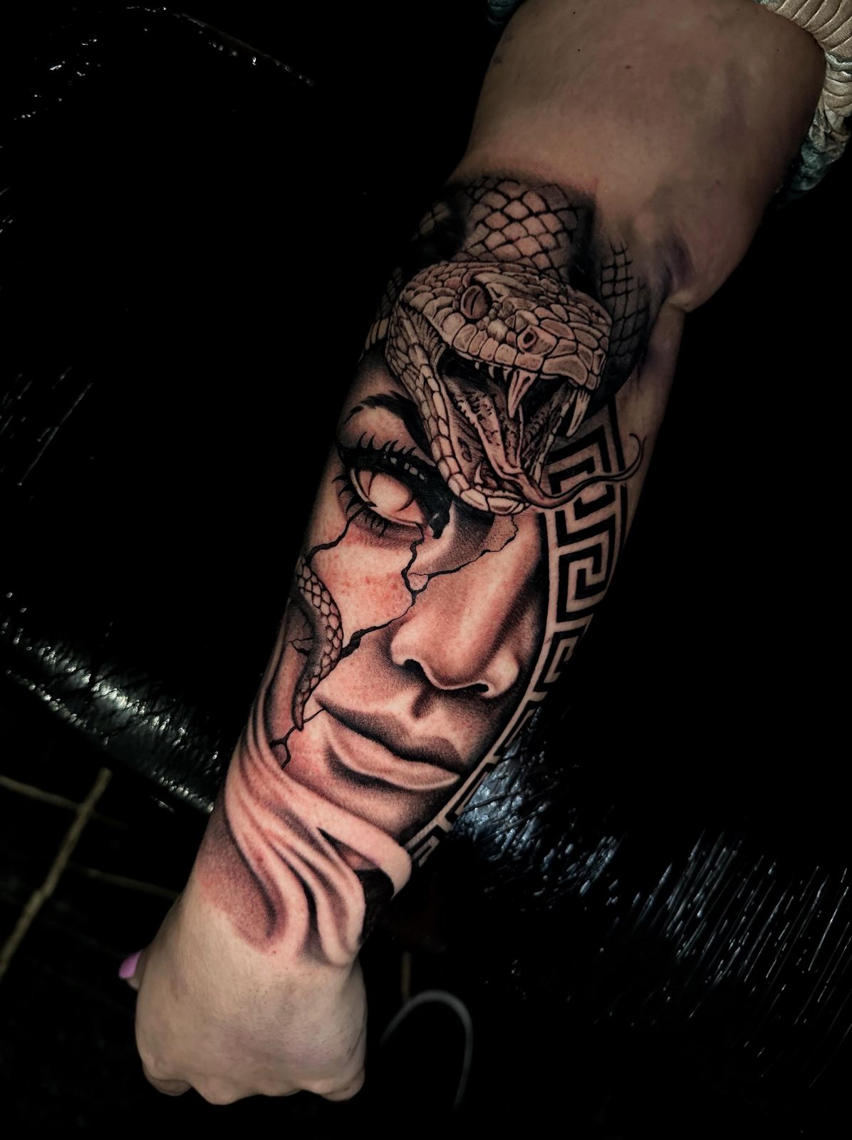 Realistic Medusa tattoo with snake